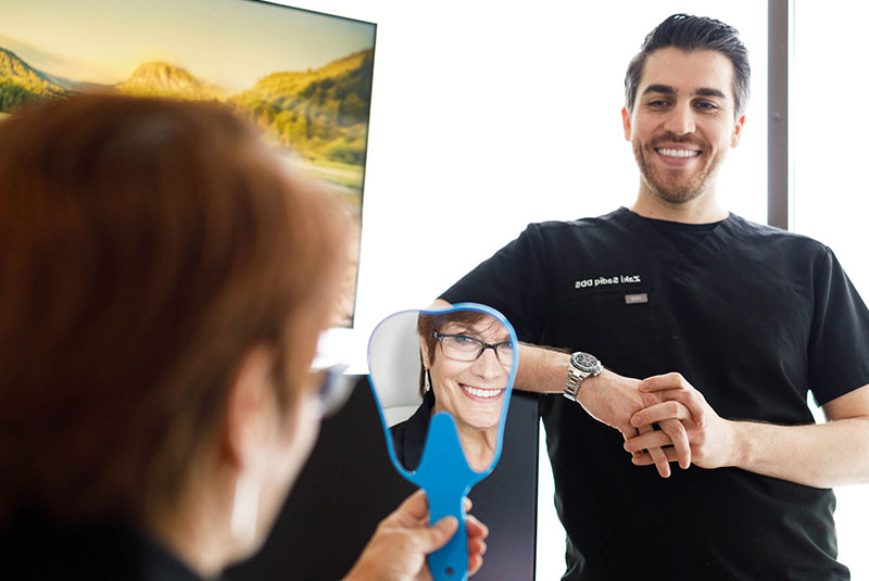 patient smiling after their dental procedure within the dental practice