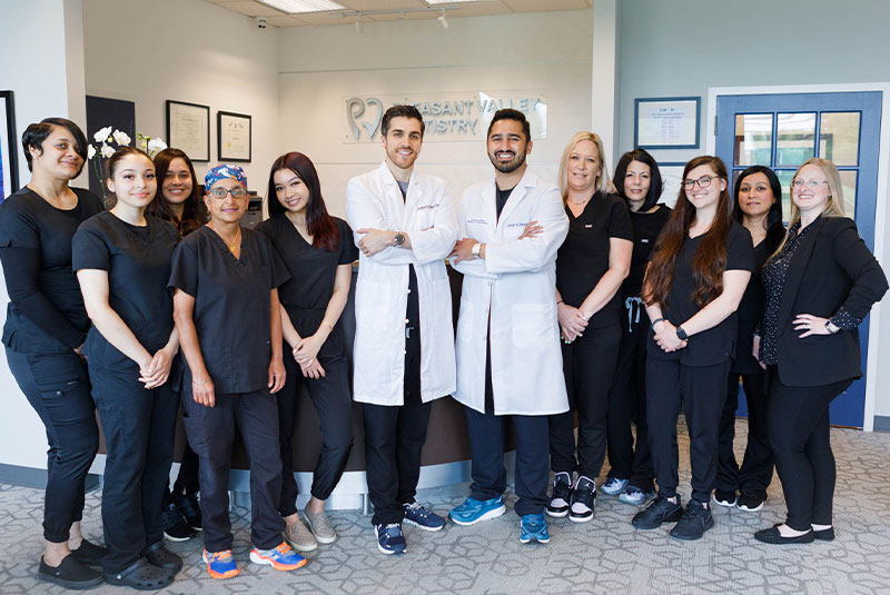 staff members taking group picture within the dental practice